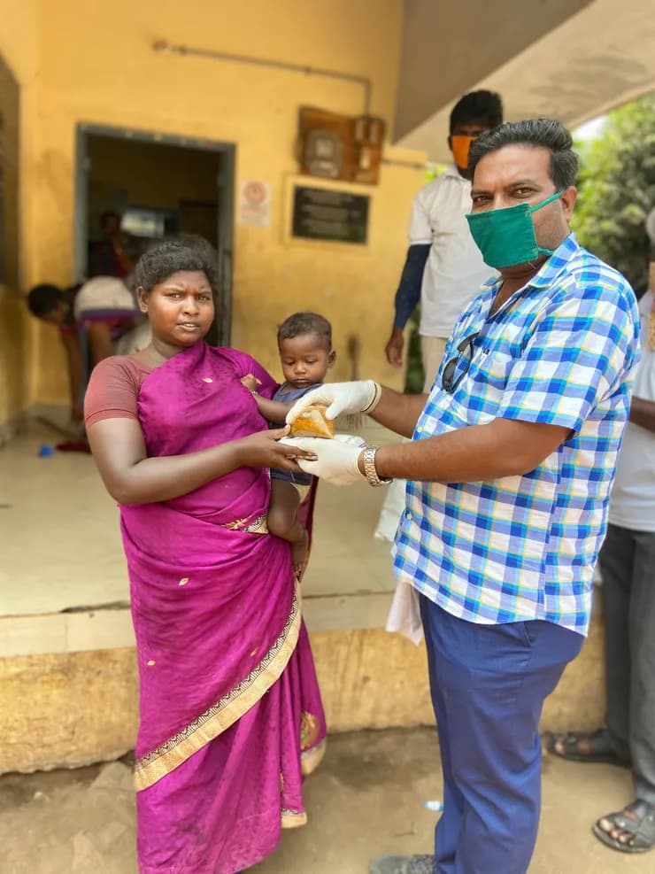 COVID feeding — family receiving food pack